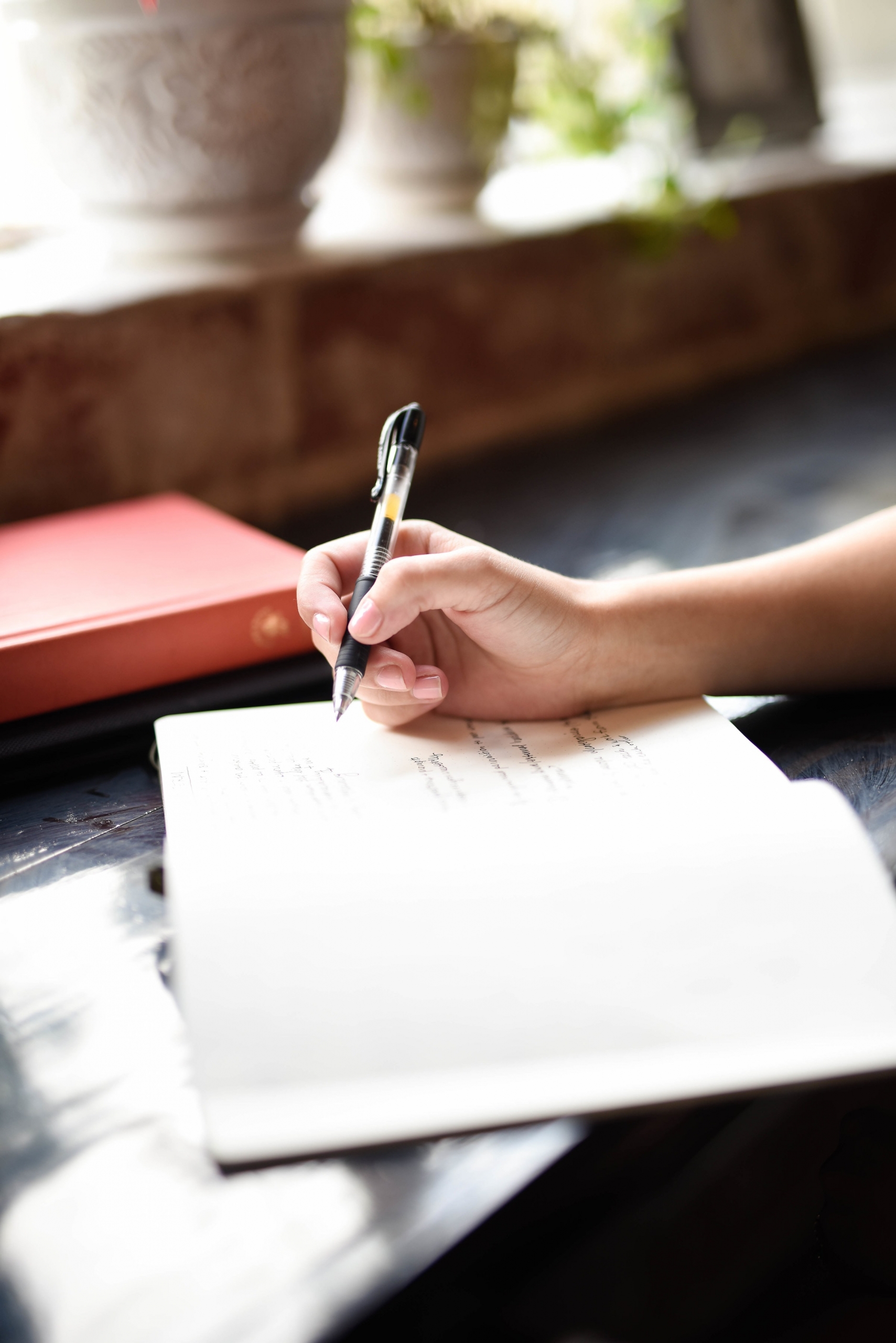 picture of a hand writing in a notebook