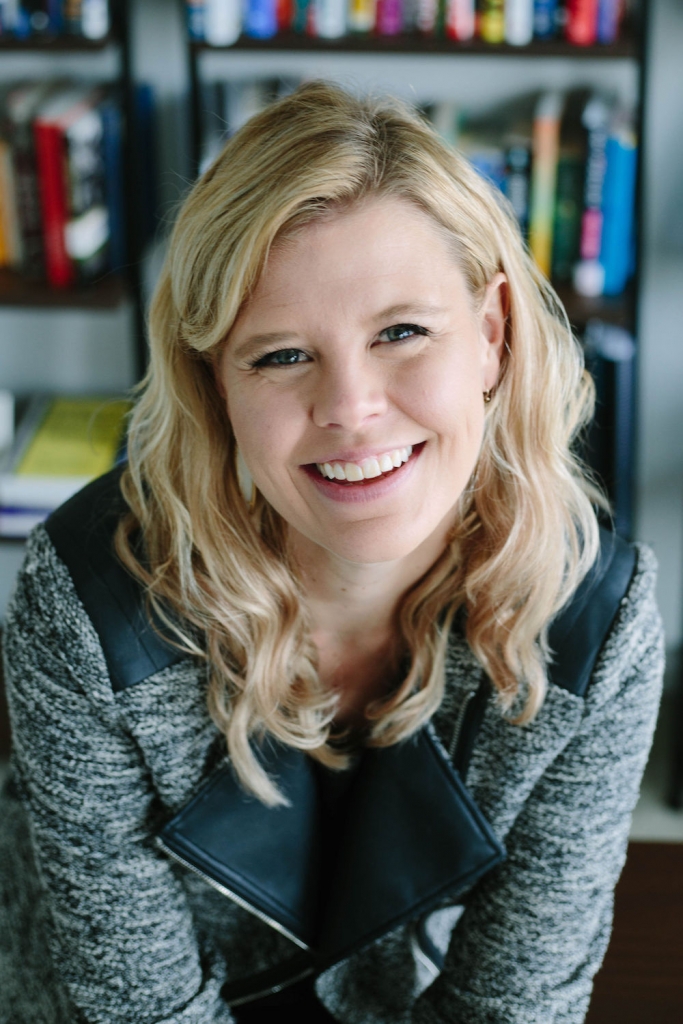 Christina smiling in her office and looking at the camera