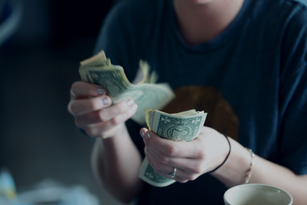 Woman holding dollar bills